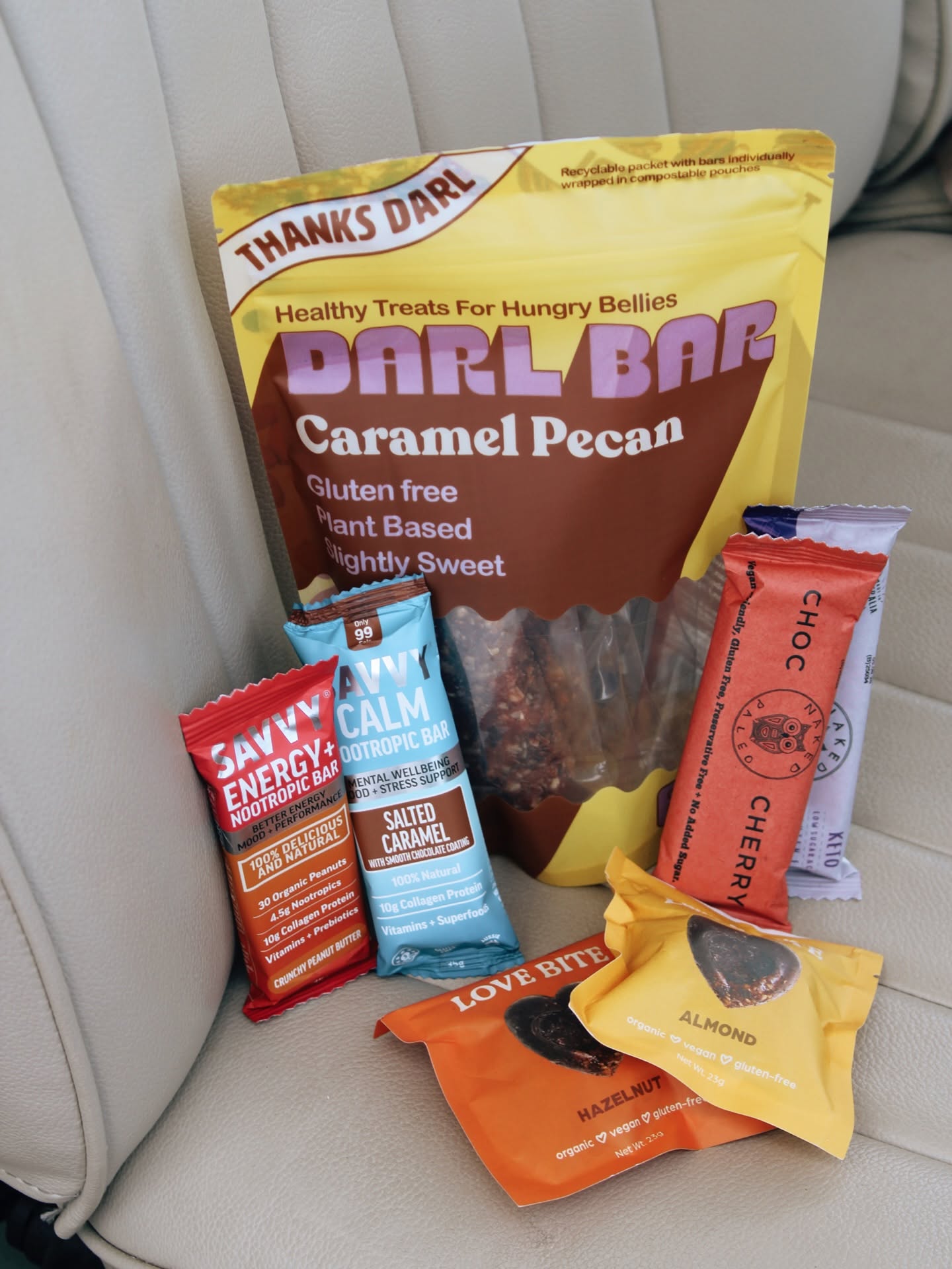Assorted wrapped snack bars on a cream seat